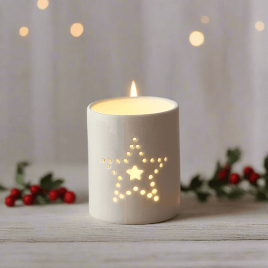 White Ceramic Tealight Holder with Dotted Star Detail. Illuminate your Christmas with elegance with this exquisite white ceramic tealight holder, with a captivating dotted star design, adds a touch of sophistication to your Christmas decor. Its sleek and 