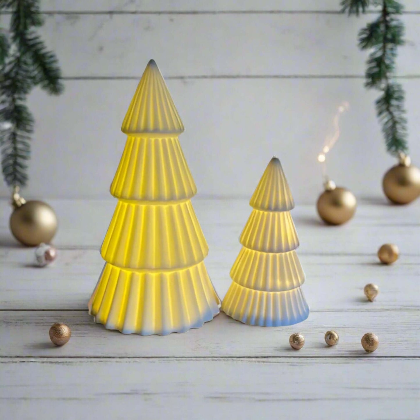 Christmas tree light-up ornament, A charming ceramic white tree ornament, featuring a matte finish and ridged detailing. Comes complete with LED lights, perfect for creating a warm and cosy ambiance for any home space. Available to purchase in two sizes: 