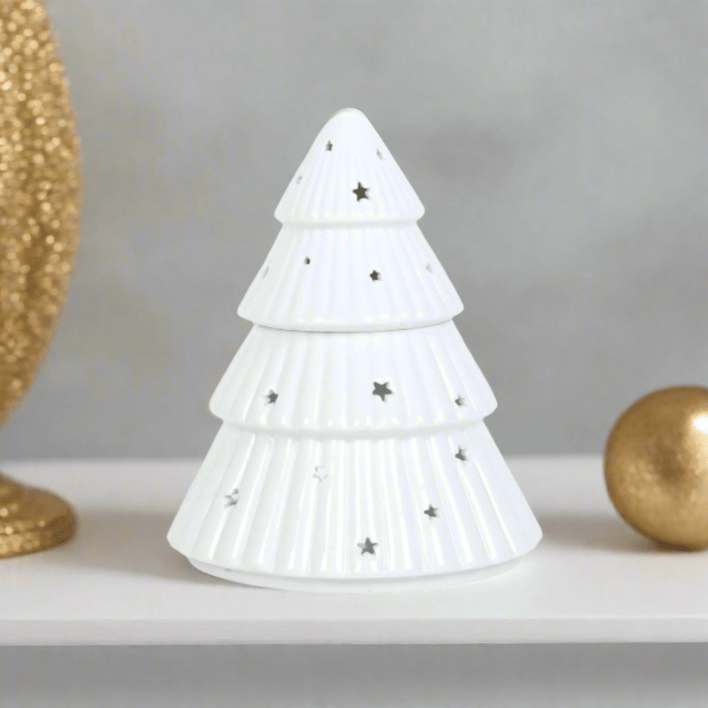 Christmas Tree Shaped Wax or Oil Burner. Add a festive touch to your home with this enchanting Christmas tree-shaped wax or oil burner. Its intricate design and classic white finish make it a captivating centerpiece to your Christmas decor.